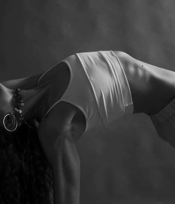 Woman in a calm, balanced yoga pose, focusing on core stability.